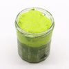 A vibrant lime-green classic mojito sugar body scrub with shea butter in a clear glass jar with an octagonal base