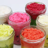 Colorful textured espresso martini sugar body scrub in clear glass jars with a rich brown sugar body blend