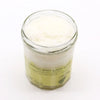 Pineapple-scented pina colada sugar body scrub with shea butter in clear glass jar with pale yellow label 300g
