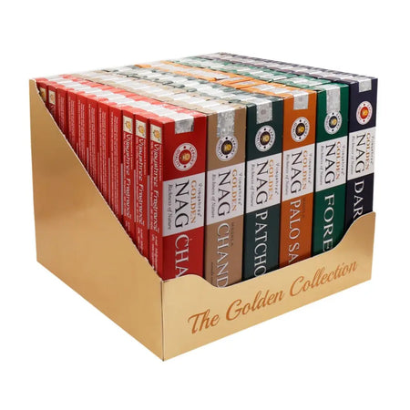 A collection of vijayshree golden nag incense sticks in colorful boxes arranged in a golden display tray