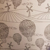 A black-and-white line drawing of patterned hot air balloons floating with clouds and wind turbines in an adult colouring book