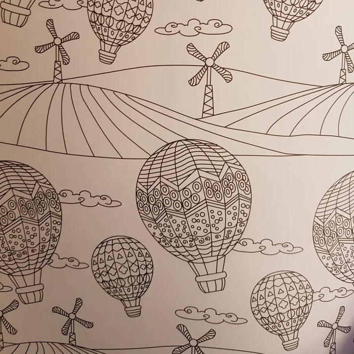 A black-and-white line drawing of patterned hot air balloons floating with clouds and wind turbines in an adult colouring book