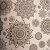 Adult colouring book with beige pages featuring intricate black mandala patterns for zen colouring