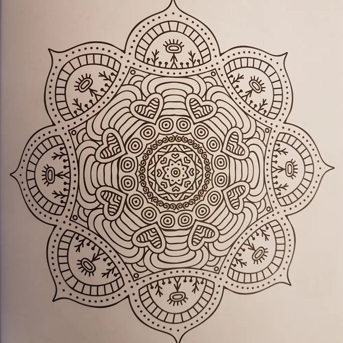 A detailed black line drawing of a symmetrical mandala with hearts and floral patterns in an adult colouring book