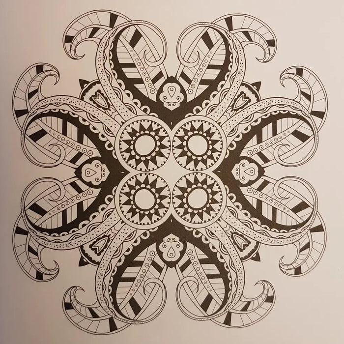 A black and white intricate mandala drawing with symmetrical paisley-like patterns in an adult colouring book