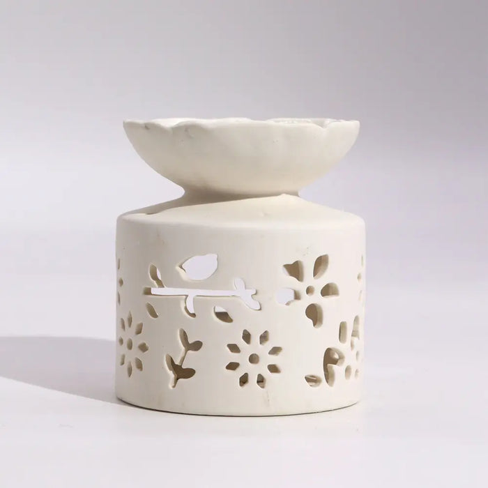 Cream-colored ceramic oil diffuser with floral cutouts in agnes and cat fragrance gift set moroccan style