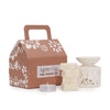 Cream-colored ceramic wax melt burner with floral cutout design in agnes & cat fragrance gift set moroccan