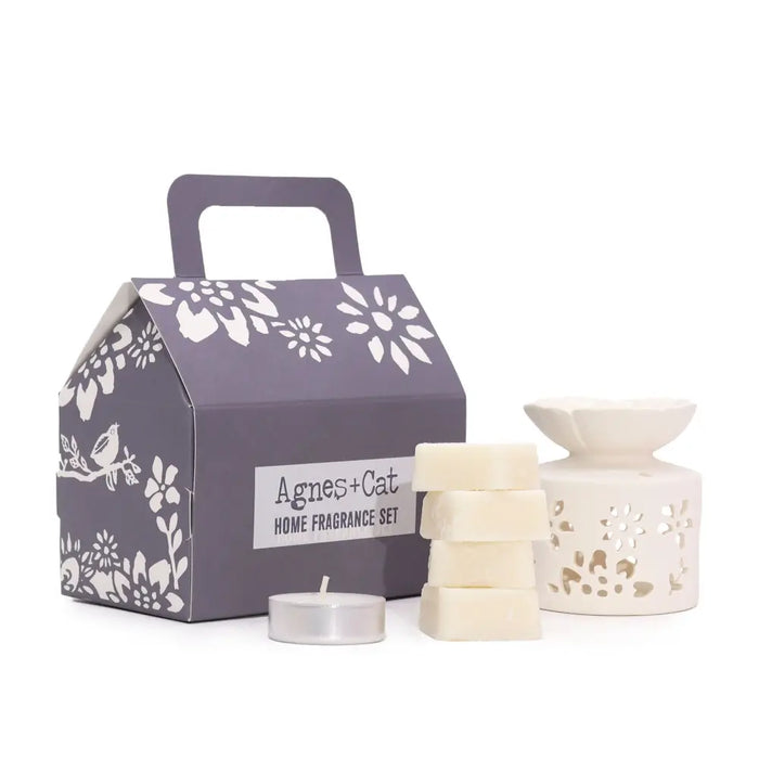 Cream-colored ceramic wax melt burner with floral cutout design in agnes & cat fragrance gift set windermere cat fragrance gift