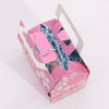 Pink paper cat wellness gift box with white floral cutouts and light blue shredded paper for wellness gift set