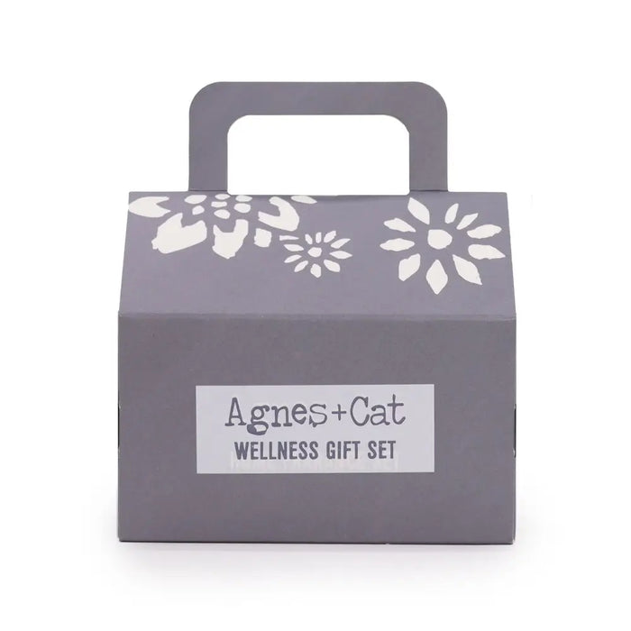 Gray cat wellness gift box with white floral cutout and handle labeled agnes cat lake breeze wellness gift set