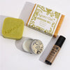 A rectangular yellow-orange moroccan soap bar wrapped in white and olive-green paper labeled agnes and cat wellness gift set
