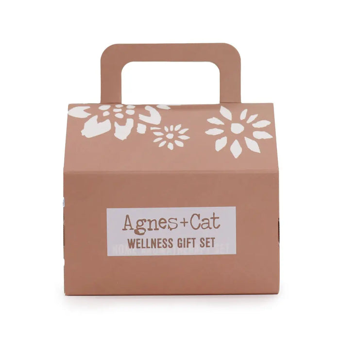 A taupe cat wellness gift box with white floral pattern and handle labeled agnes and cat wellness gift set moroccan morning
