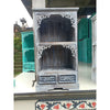 Gray wooden albasia bathroom cabinet with intricate white carved details and two drawers at the base