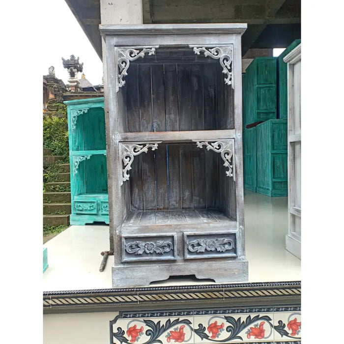 Gray wooden albasia bathroom cabinet with intricate white carved details and two drawers at the base