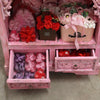 Pink floral arrangement in a matching pink basket with gingham ribbon on an albasia bathroom cabinet pink wash