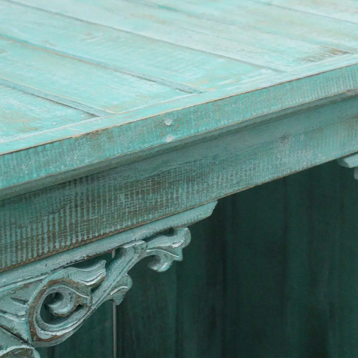 Albasia bathroom cabinet with teal distressed wood table and ornate carved corner support in turquoise wash finish