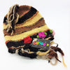 A hand-knitted multicolored wool and silk beanie with frayed tassels and crocheted flower embellishments for adults