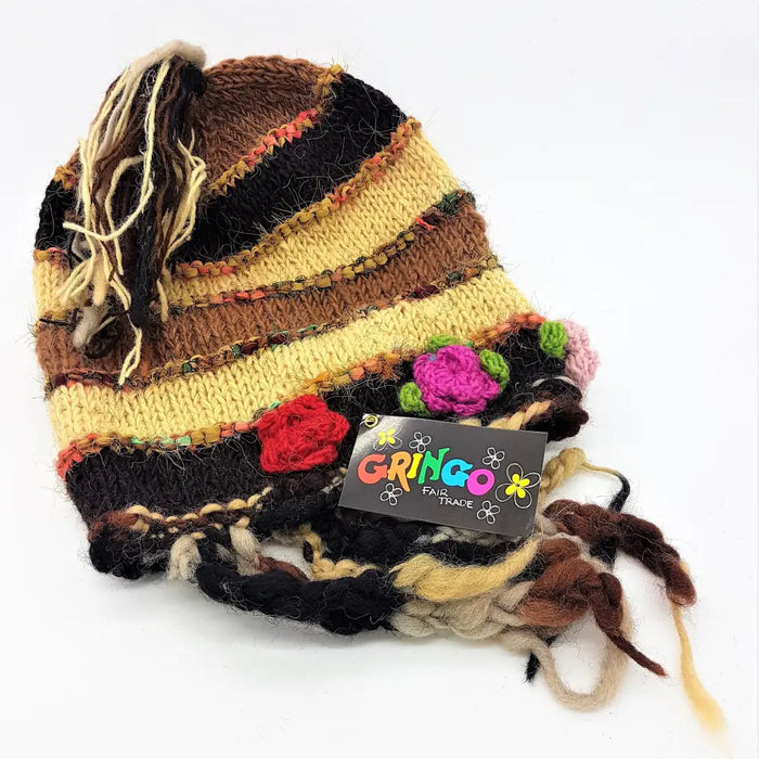 A hand-knitted multicolored wool and silk beanie with frayed tassels and crocheted flower embellishments for adults