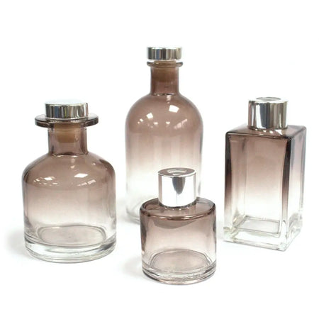 Set of four apothecary style gradient brown glass diffuser bottles with silver caps and gold finish for bamboo reed diffuser