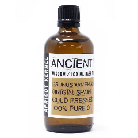 A brown glass bottle of ancient apricot kernel oil with a black cap and white label showing 100ml pure kernel oil
