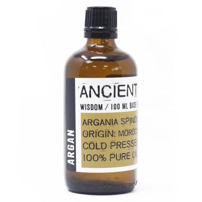 A 100ml amber glass bottle of argan oil from morocco with a black ribbed cap and a white label with gold text