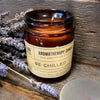 A brown glass jar soy wax aromatherapy candle labeled be chilled with lavender and ferns scent