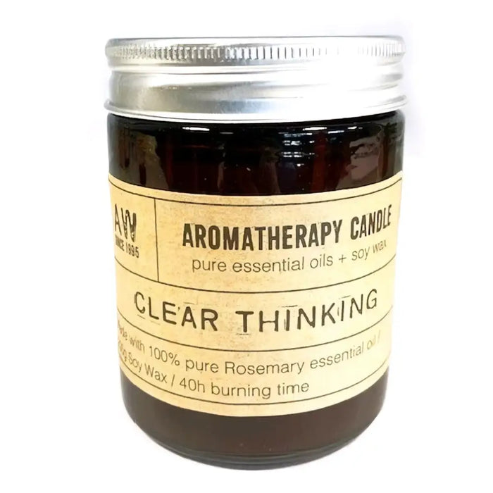 A dark amber glass jar with silver lid and beige label containing a soy wax aromatherapy candle for clear thinking