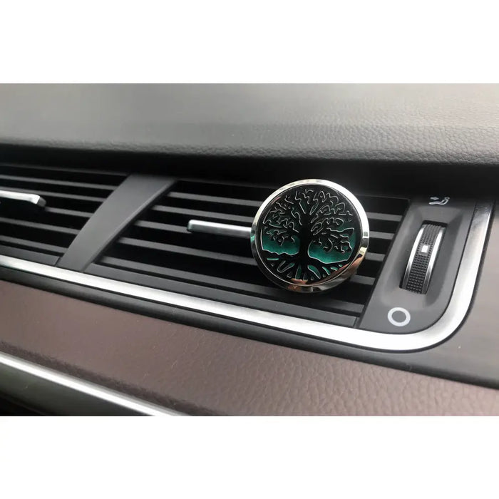 Circular car air freshener with teal tree of life design and stainless steel frame for vent attachment in aromatherapy kit