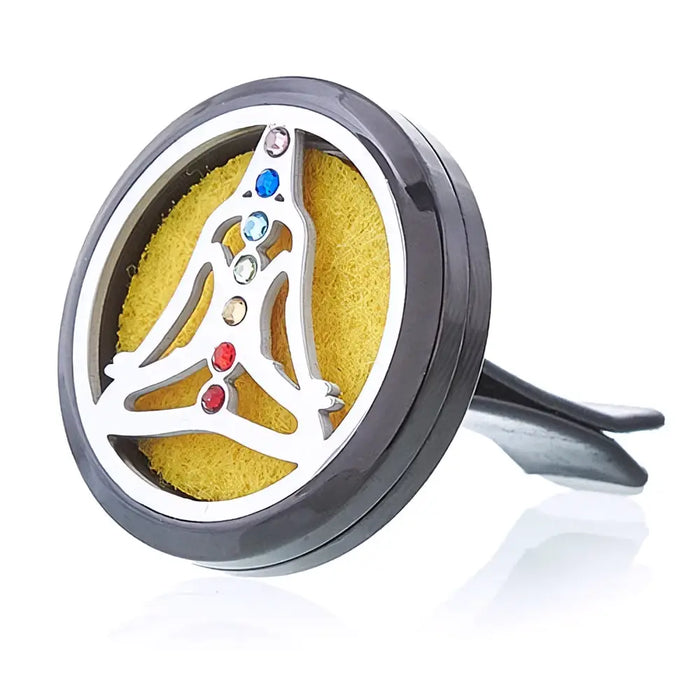 A sleek black and silver stainless steel car air freshener with chakra design and colorful gemstones in a triangular pattern