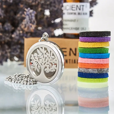 Silver tree of life aromatherapy diffuser necklace with circular metal body and attached beaded chain in 30mm size