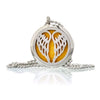 Silver circular aromatherapy diffuser necklace with wing-like cutouts holding a yellow essential oil pad