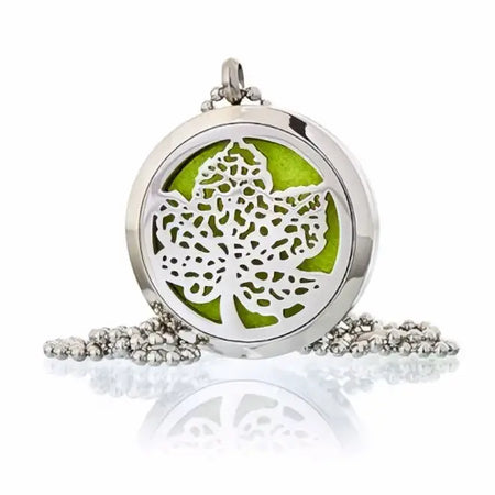 Silver aromatherapy diffuser necklace with 30mm circular locket, leaf cutout, green inner panel, and beaded chain