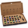 A cardboard gift box with ten aromatherapy essential oil bottles each with black caps and colorful scent labels