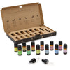 Set of twelve aromatherapy essential oil bottles with black caps and colorful labels in a brown cardboard gift box