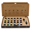 A set of ten colorful aromatherapy essential oil bottles with black caps in a brown cardboard gift box labeled with scents