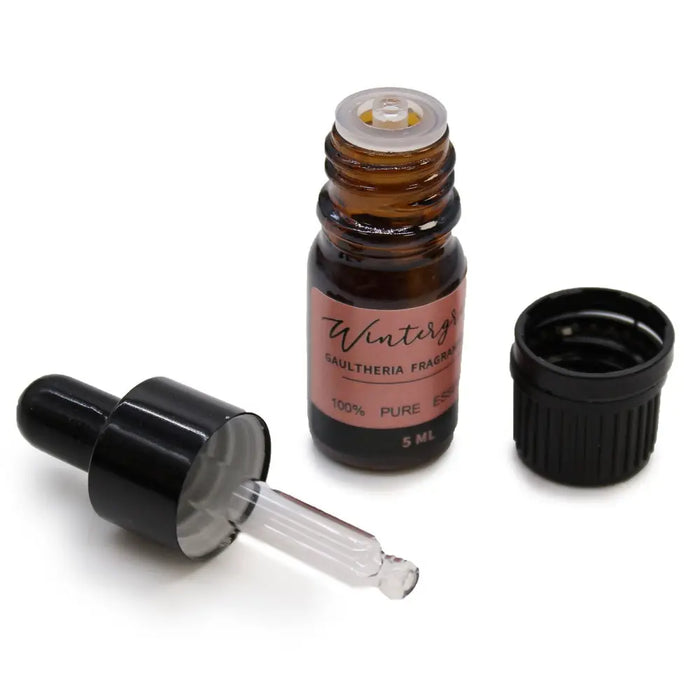 A 5ml amber glass bottle with black dropper and pink label in an aromatherapy essential oil set starter pack