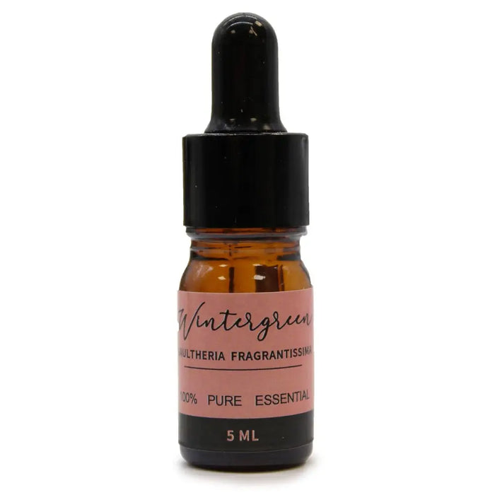 A small amber glass bottle with a black dropper cap and pink label of wintergreen aromatherapy essential oil set