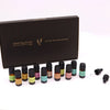 Aromatherapy essential oil set with assorted colored labels and black caps beside a dark brown gift box for summer