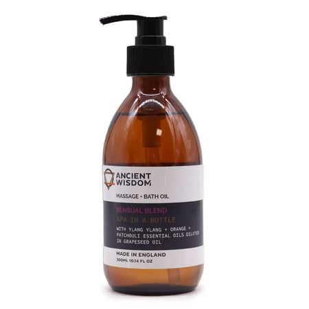 A sleek amber glass bottle with black pump labeled ancient wisdom massage and bath oil sensual 300ml