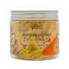 A clear glass jar with silver lid holds yellow whipped soap infused with orange and lemon peel oil and vitamin c