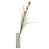 A tall arrangement of artificial dusky pink poppy pods and green stems in a clear rectangular glass vase