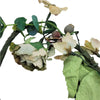 A delicate artificial wild roses branch with cream blossoms green leaves and berries for church pillar candles decor