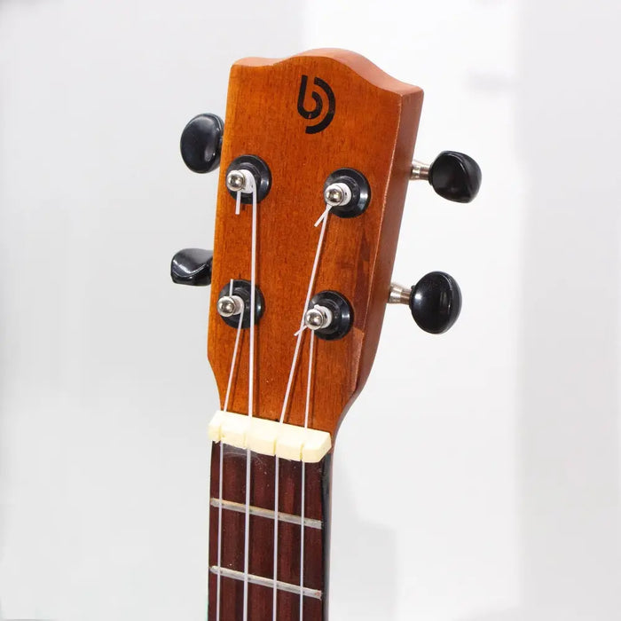 A polished wooden ukulele headstock with black tuning pegs and a warm orange sunburst finish
