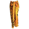 Yellow silk sarong with black and green tribal patterns tied at the waist from bali sarongs gecko collection