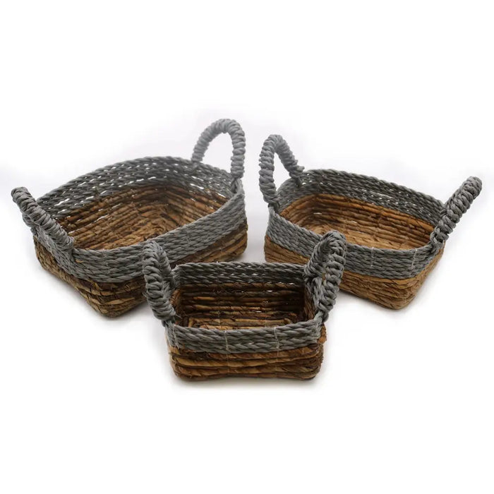 Set of three woven rectangular banana leaf and abu-abu raffia baskets with gray and brown natural fiber and twisted handles