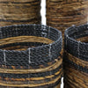 Handwoven black and tan banana leaf basket with textured natural fibers, part of a set with vases and bins