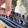 Black and white herringbone knitted zipper pull with bronze slider on grey stripes banjar laptop bag