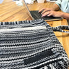 Banjar laptop bag with black and white herringbone pattern, silver zipper, and black velcro patch in grey stripes design