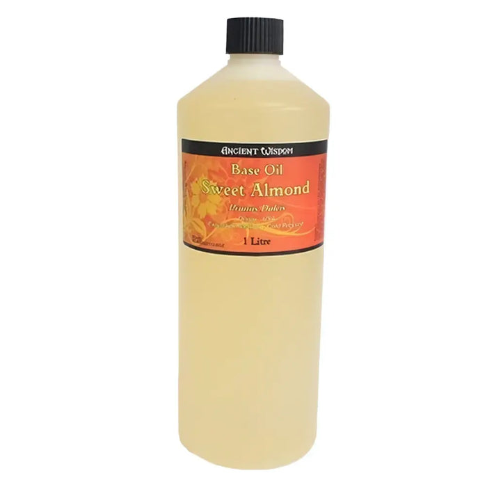 A 1 litre translucent plastic bottle of ancient wisdom sweet almond base carrier oil with a black screw-top cap
