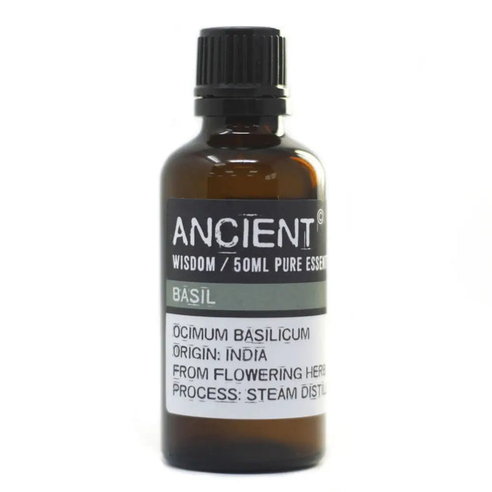 A dark amber glass bottle with a black cap labeled ancient wisdom 50ml pure essential basil essential oil with allergen declarations